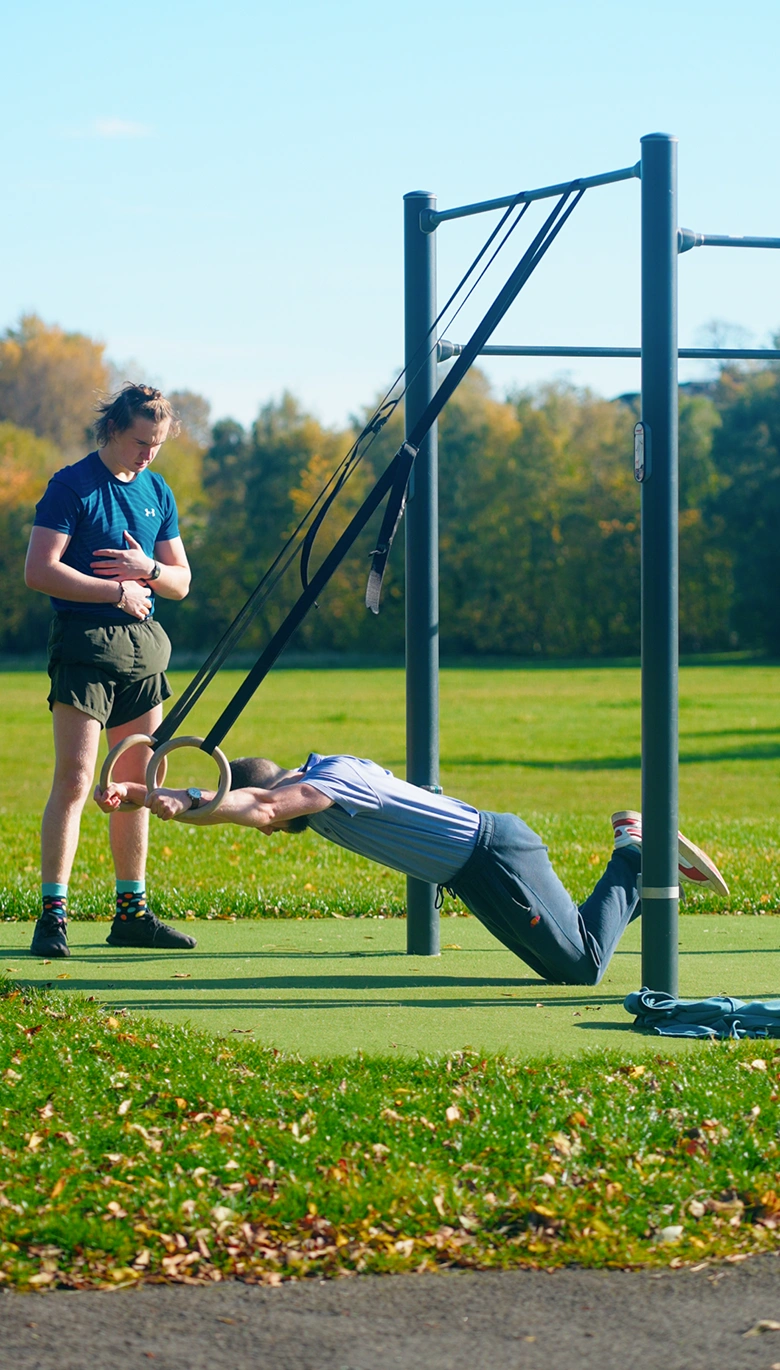 Patrick coaching a client on gymnastic rings, Glasgow